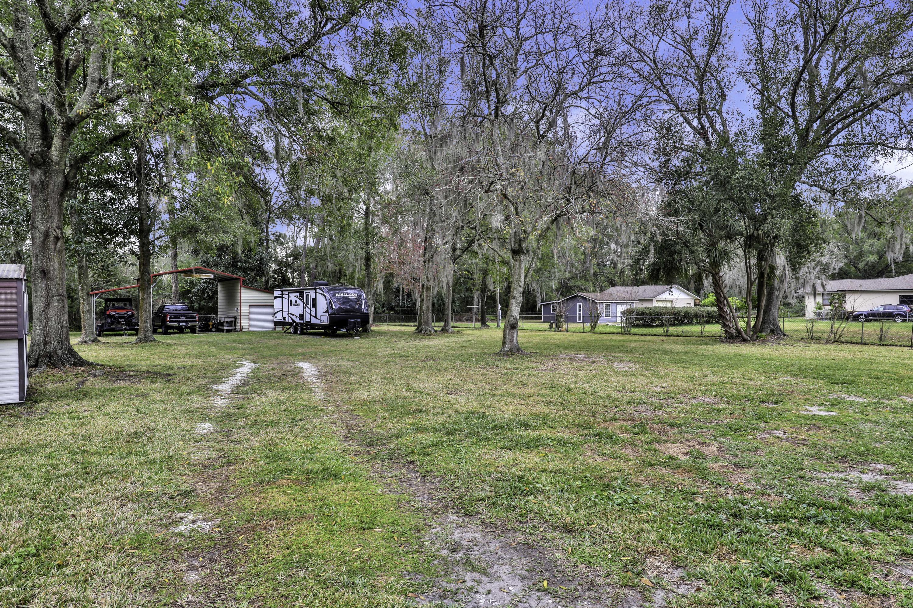 6161 Carlton Road Jacksonville, FL 32244 - Photo 20 of 26 a view of a yard with a house in the background