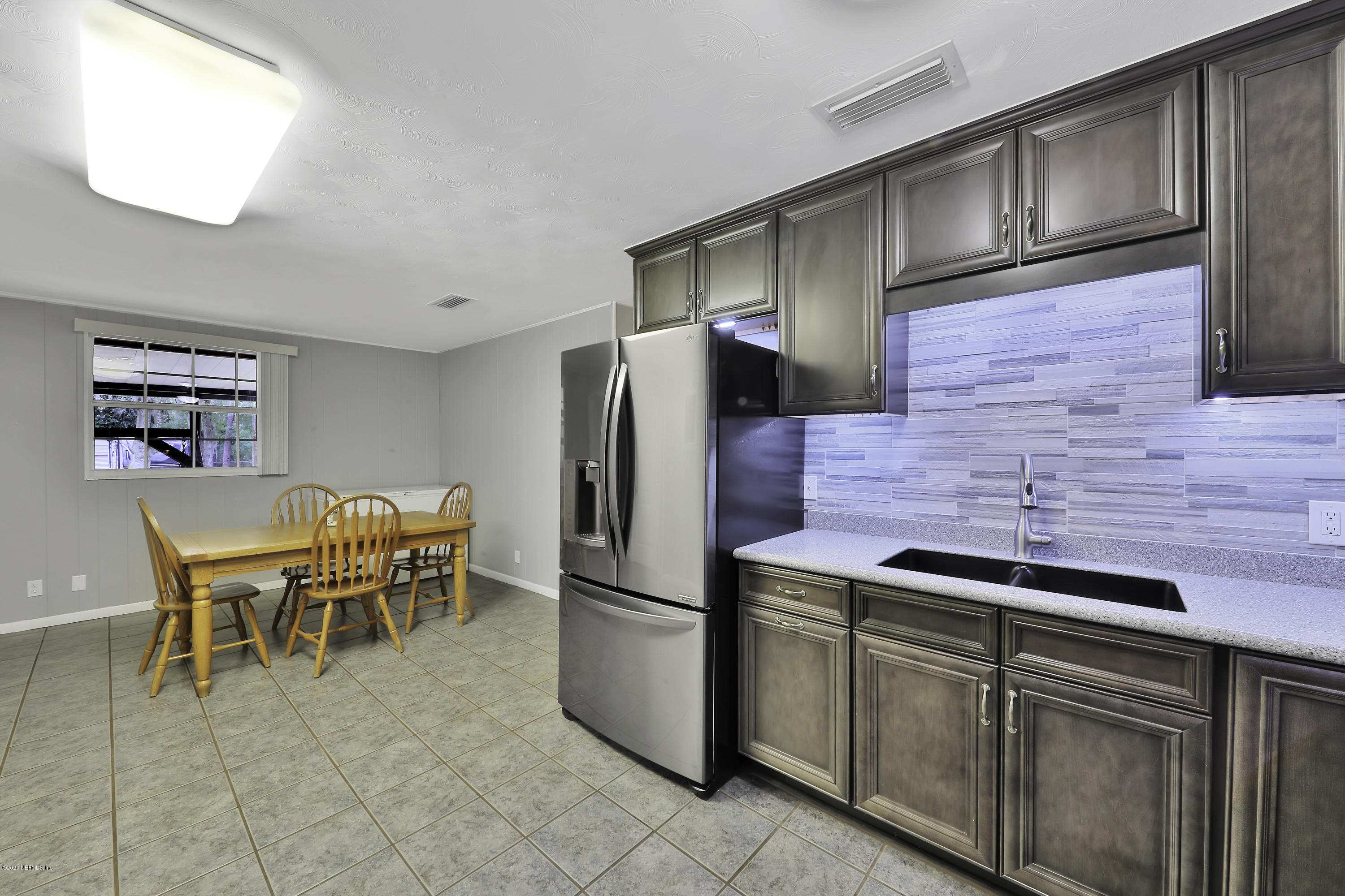 6161 Carlton Road Jacksonville, FL 32244 - Photo 6 of 26 a kitchen with stainless steel appliances granite countertop a refrigerator and a stove top oven