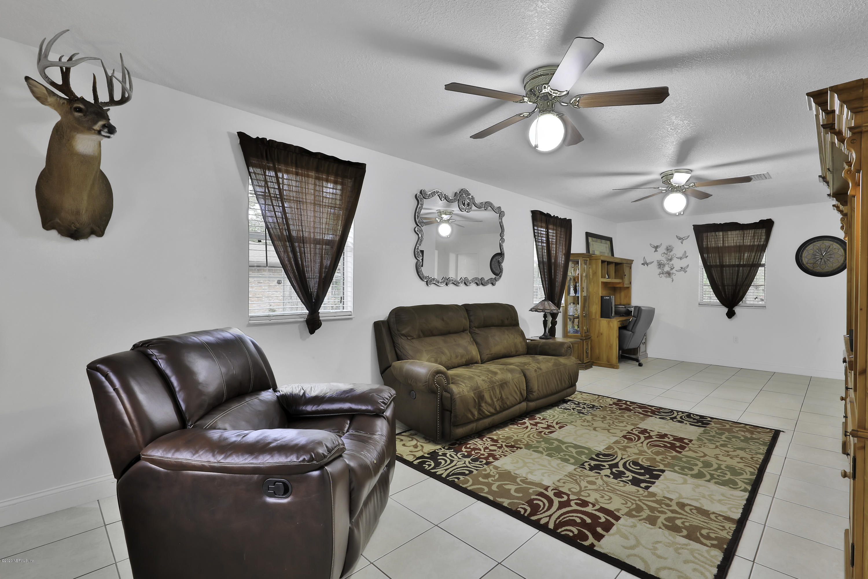 6161 Carlton Road Jacksonville, FL 32244 - Photo 9 of 26 a living room with furniture and a rug