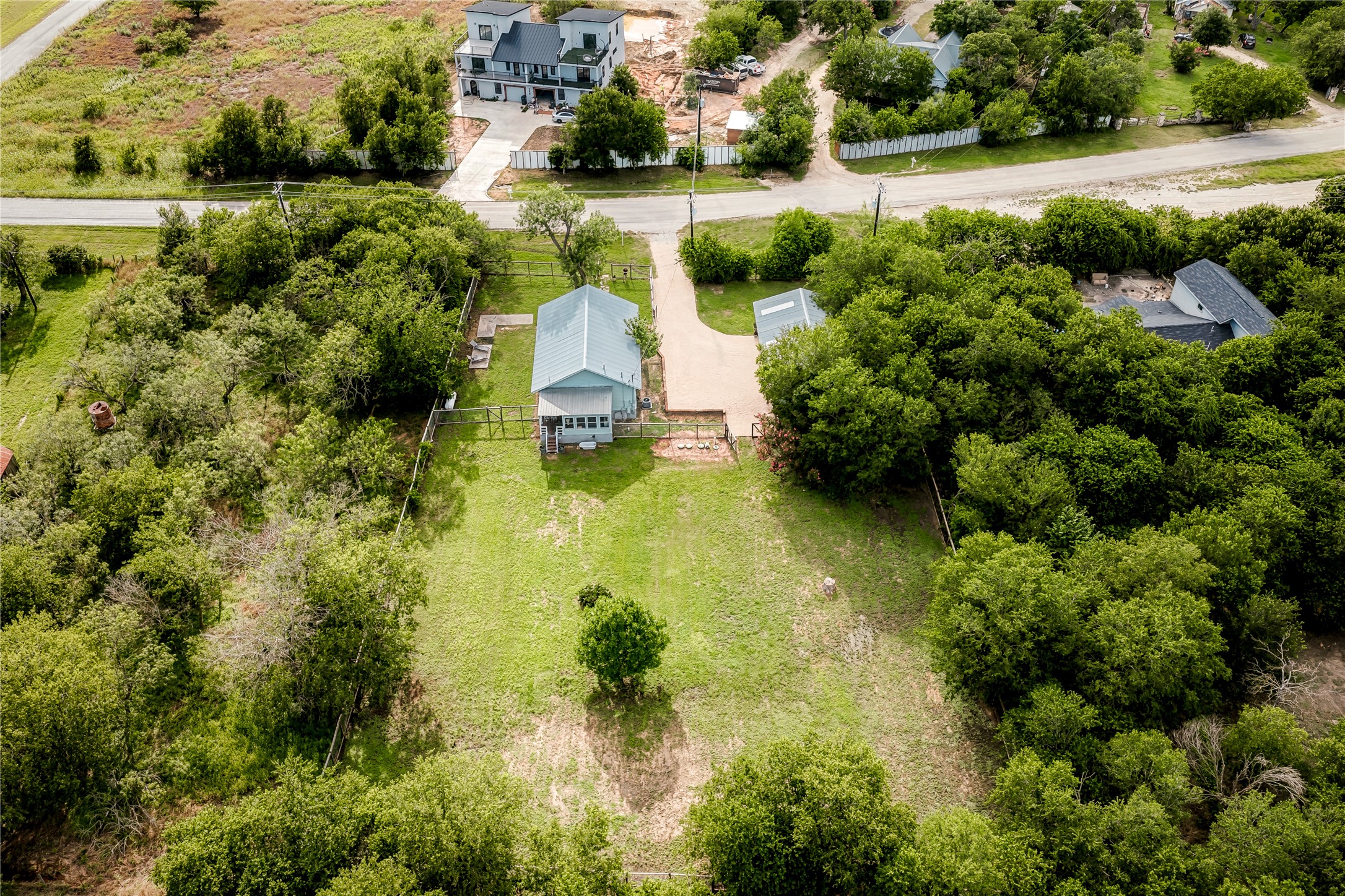 372 Old Lockhart Road Lockhart, TX 78644 - Photo 39 of 40 A private, fenced property featuring a charming residence and ample green space.