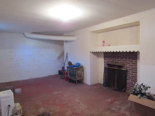 a view of a livingroom with furniture and a fireplace