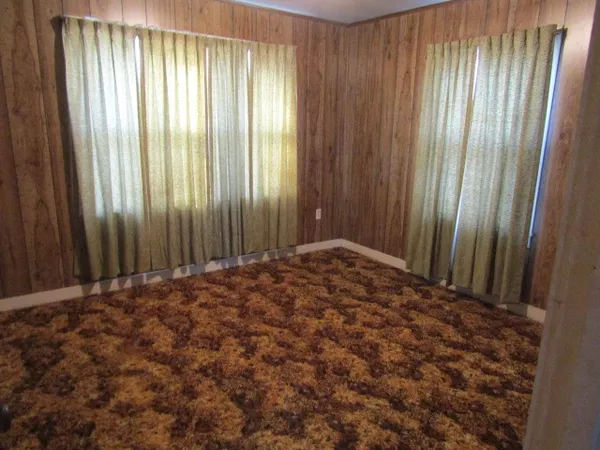 a view of a room with a window and a door