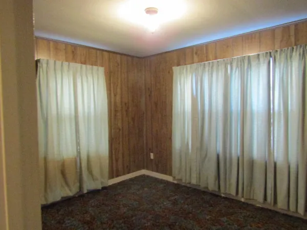 a view of a room with a wooden door