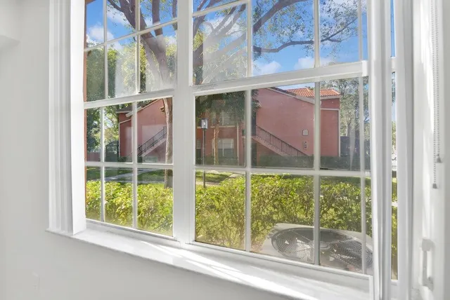a view of a glass door with a yard from a window
