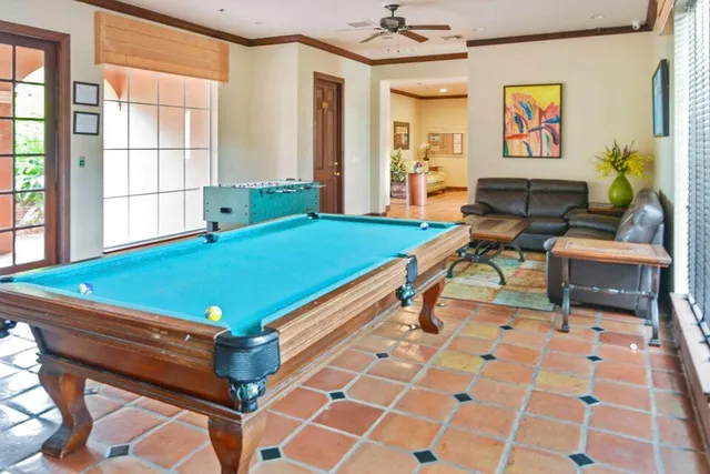 a view of a living room with furniture and windows
