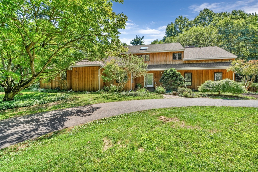 66 Taylor Road Stow, MA 01775 - Photo 1 of 42 a front view of a house with garden