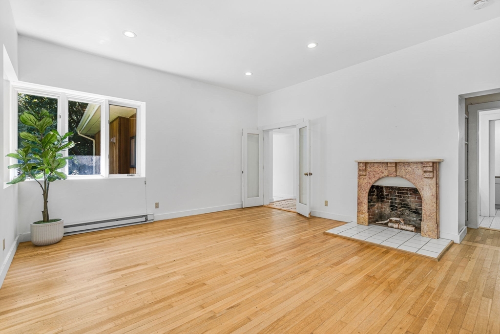 66 Taylor Road Stow, MA 01775 - Photo 15 of 42 a view of an empty room with a fireplace and a window