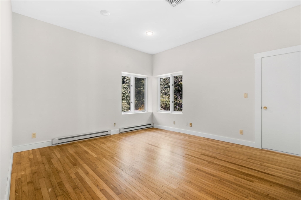 66 Taylor Road Stow, MA 01775 - Photo 19 of 42 an empty room with wooden floor and windows