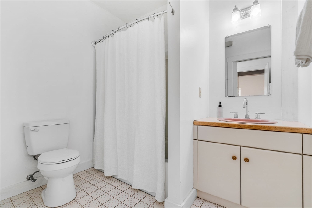 66 Taylor Road Stow, MA 01775 - Photo 22 of 42 a bathroom with a toilet sink and mirror