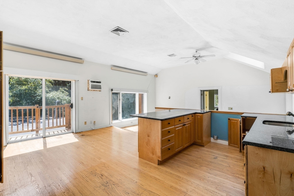 66 Taylor Road Stow, MA 01775 - Photo 24 of 42 a kitchen with stainless steel appliances granite countertop a sink stove and wooden floor
