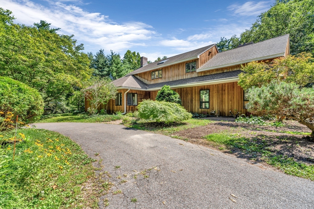66 Taylor Road Stow, MA 01775 - Photo 36 of 42 front view of a house with a yard