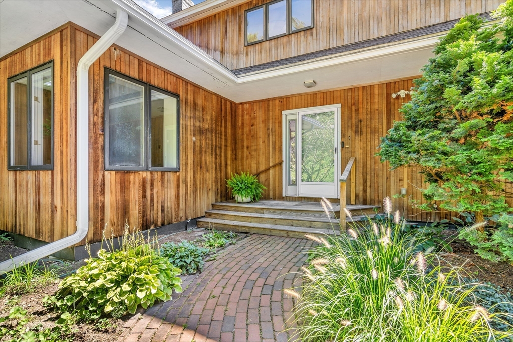 66 Taylor Road Stow, MA 01775 - Photo 4 of 42 a front view of a house with a garden