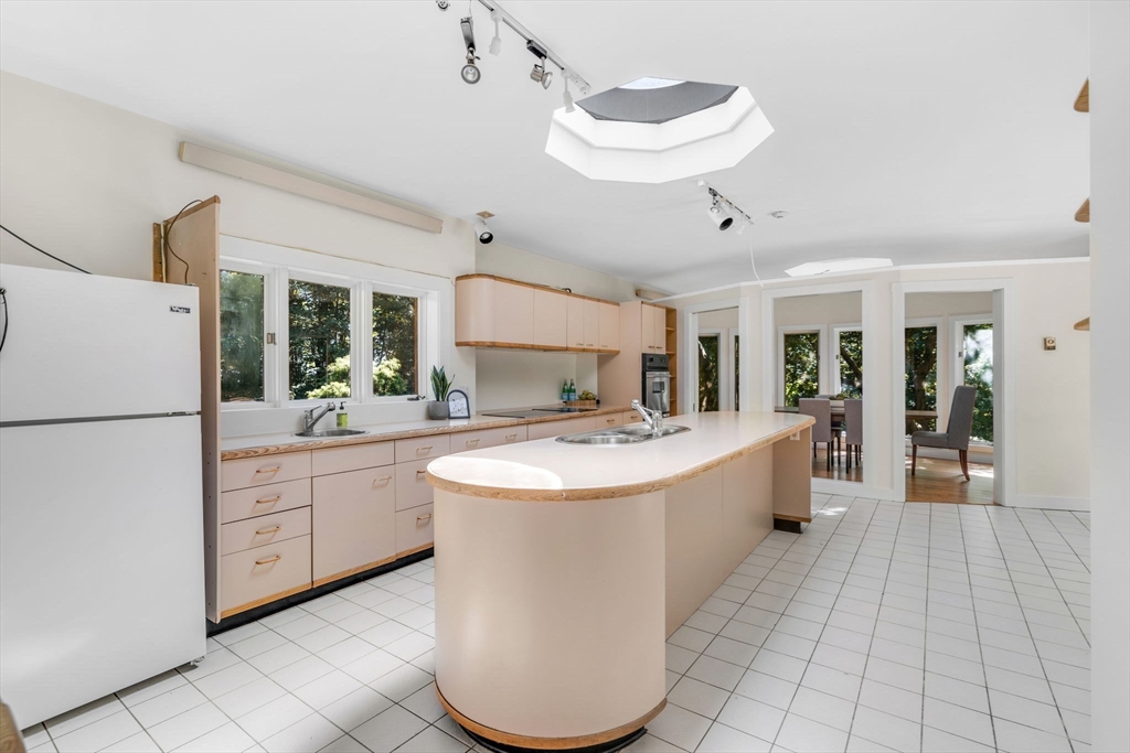 66 Taylor Road Stow, MA 01775 - Photo 10 of 42 a large white kitchen with a large window and refrigerator