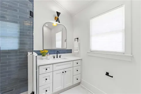 a bathroom with a double vanity sink and a mirror