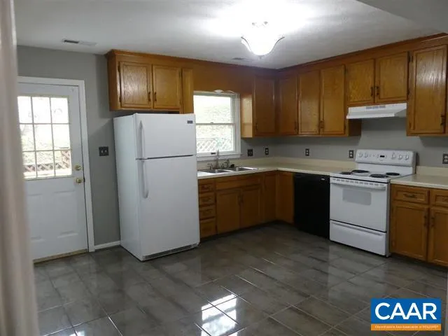 a kitchen with a sink appliances and cabinets