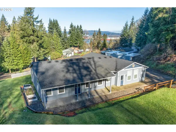 a view of a house with a yard and sitting area