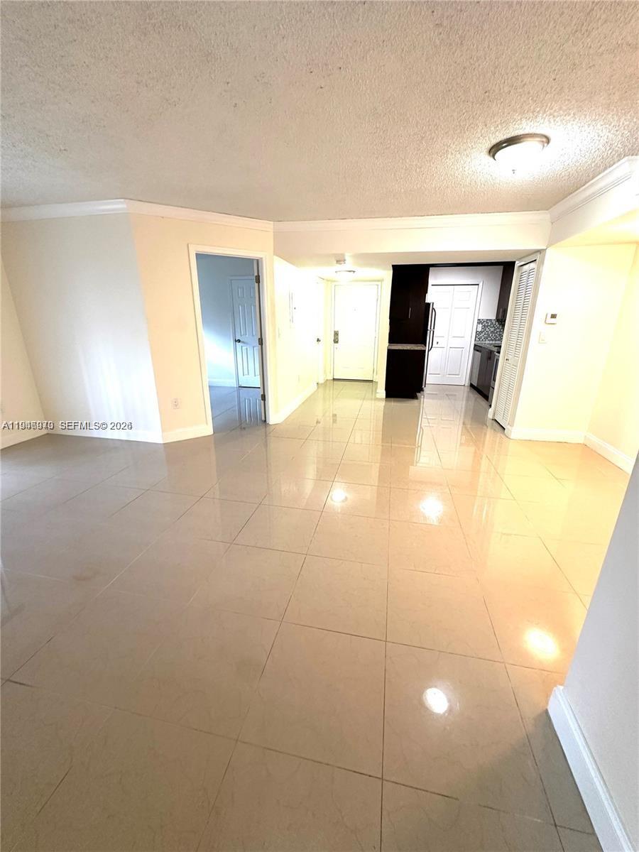 919 Northeast 199th Street, Unit 104 Miami, FL 33179 - Photo 13 of 19 a view of a living room with a white wall