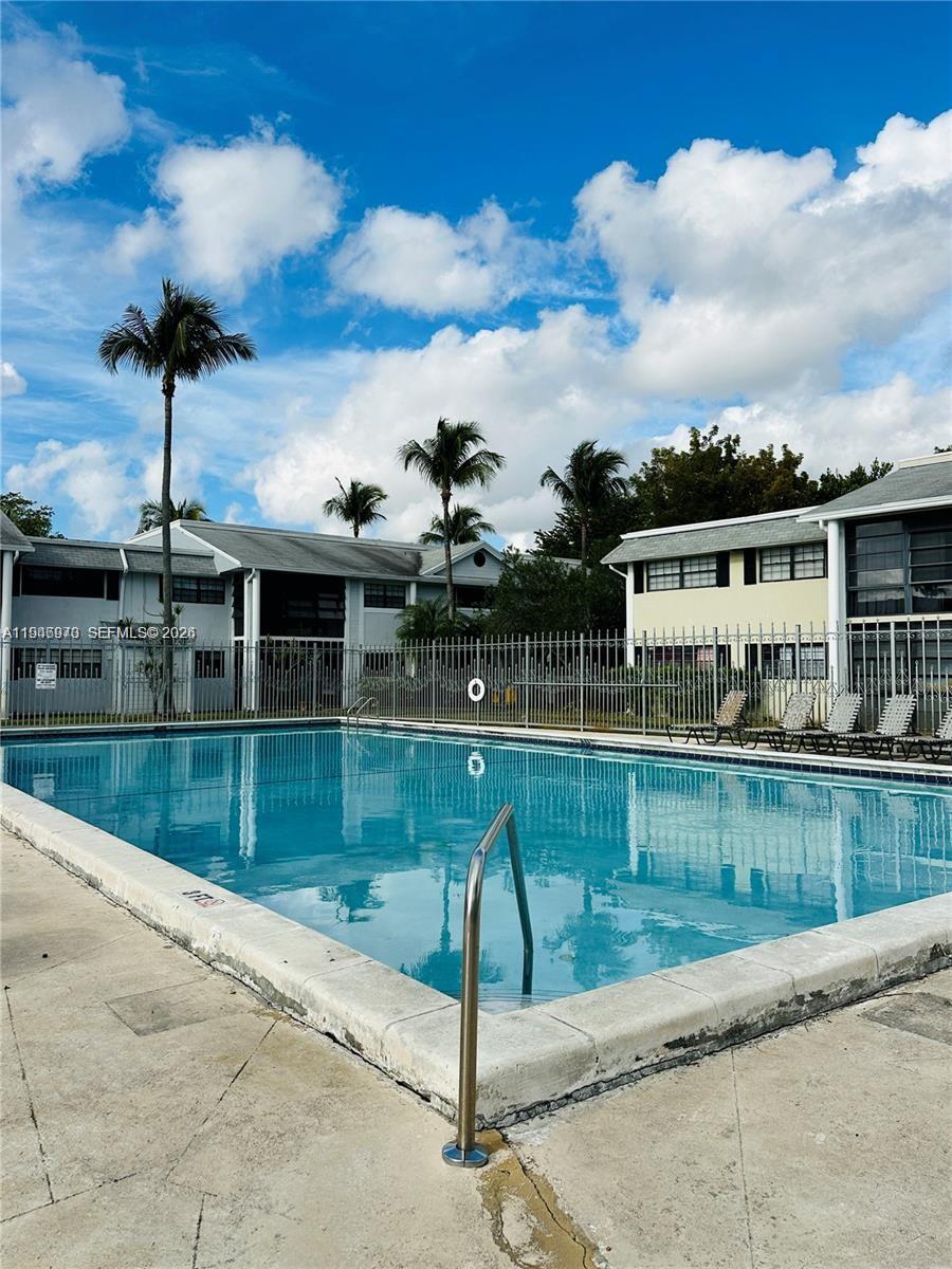 919 Northeast 199th Street, Unit 104 Miami, FL 33179 - Photo 17 of 19 a view of a house with a swimming pool