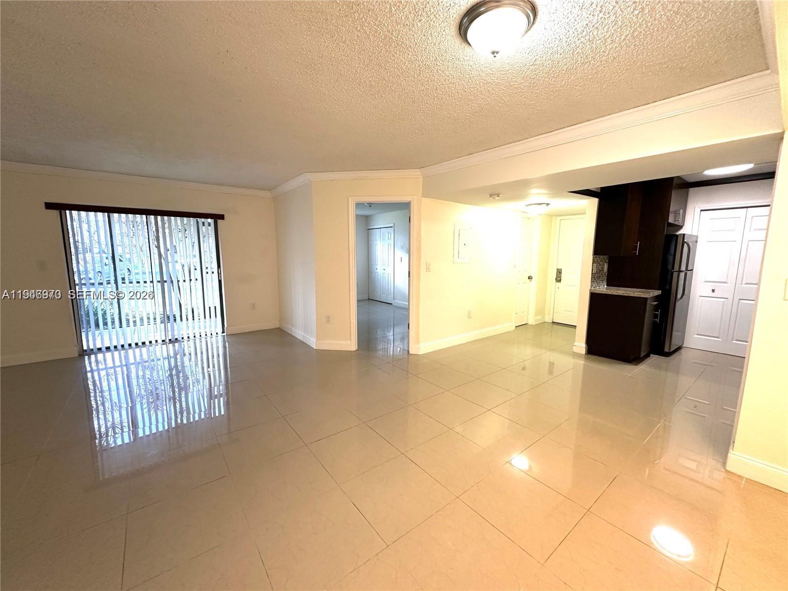 919 Northeast 199th Street, Unit 104 Miami, FL 33179 - Photo 3 of 19 a view of entryway with wooden floor