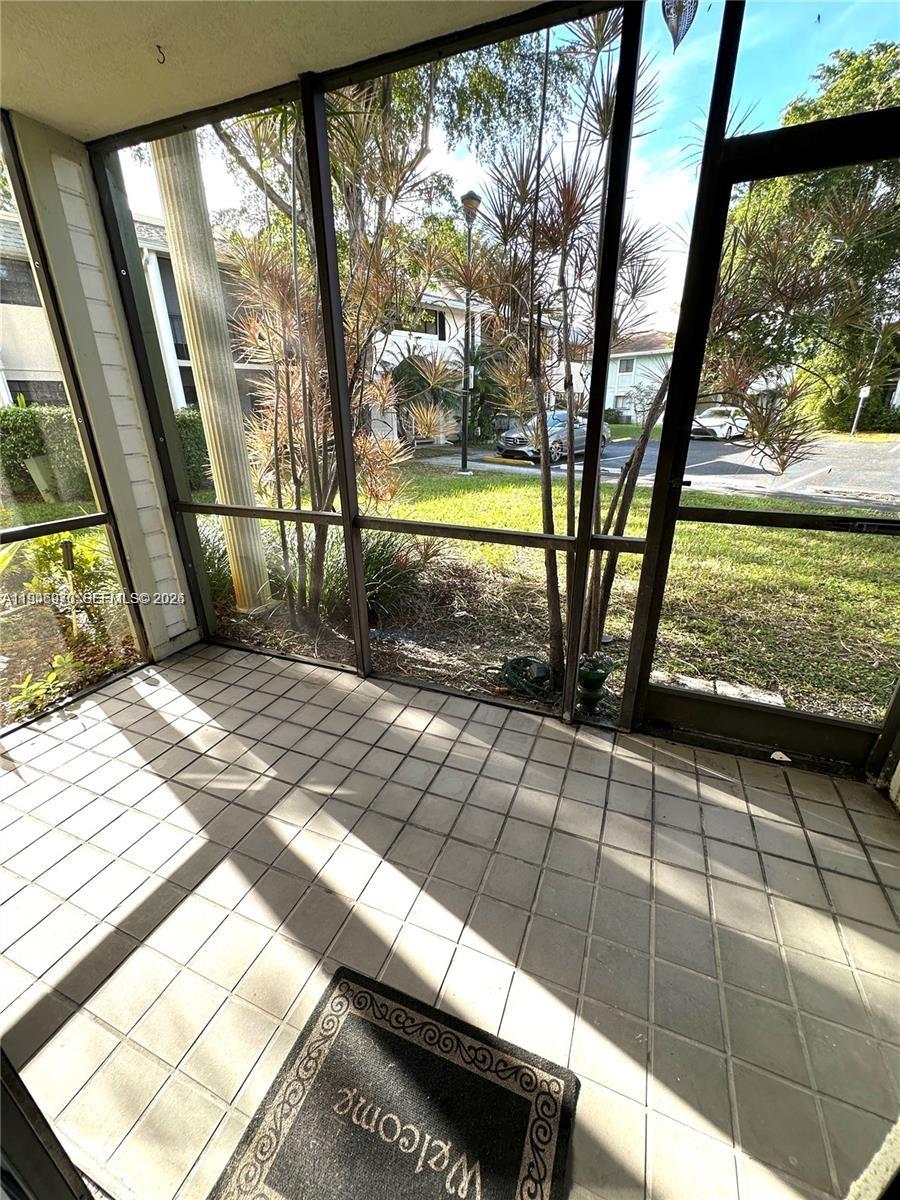 919 Northeast 199th Street, Unit 104 Miami, FL 33179 - Photo 6 of 19 a view of a porch with seating space