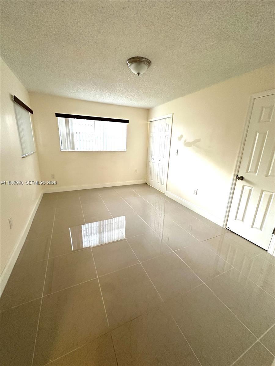 919 Northeast 199th Street, Unit 104 Miami, FL 33179 - Photo 10 of 19 a view of an empty room