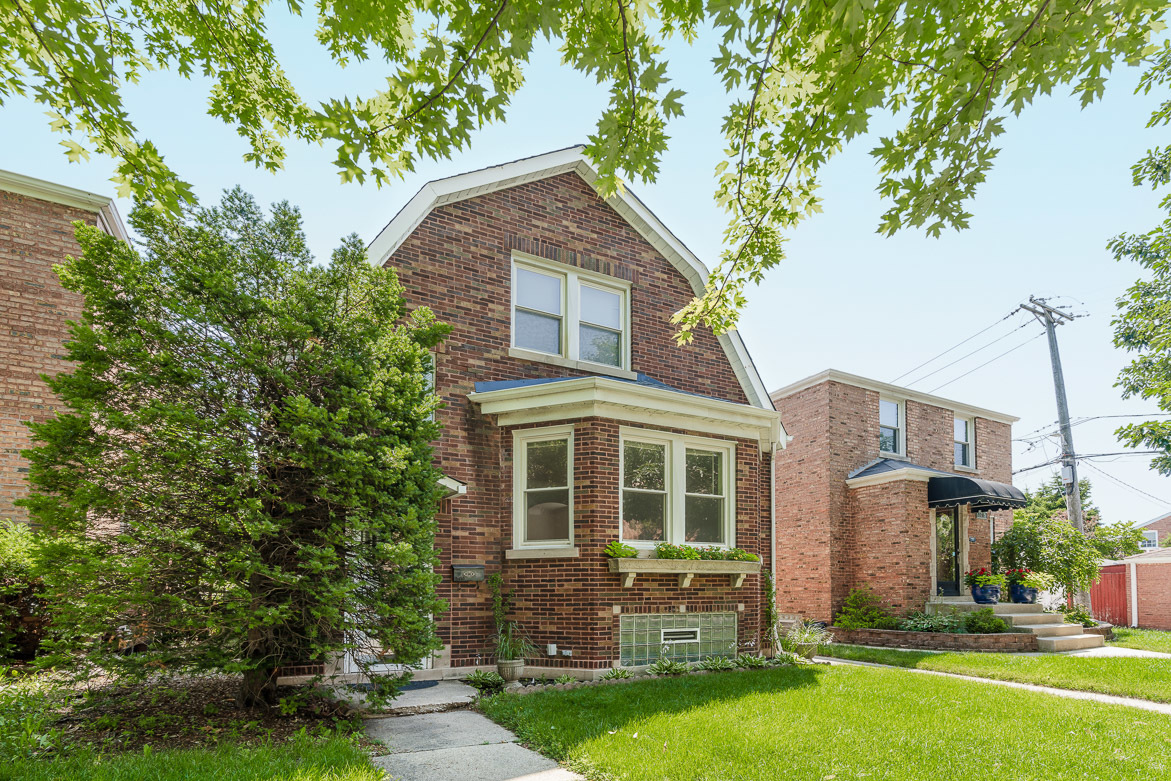 5219 North Rutherford Avenue, Unit 2 Chicago, IL 60656 - Photo 1 of 10 front view of a house with a yard