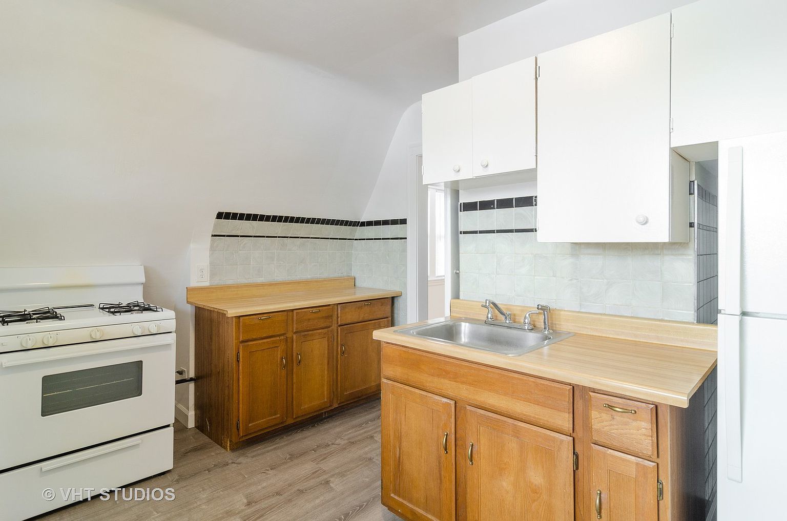 5219 North Rutherford Avenue, Unit 2 Chicago, IL 60656 - Photo 6 of 10 a kitchen with a sink stove and cabinets