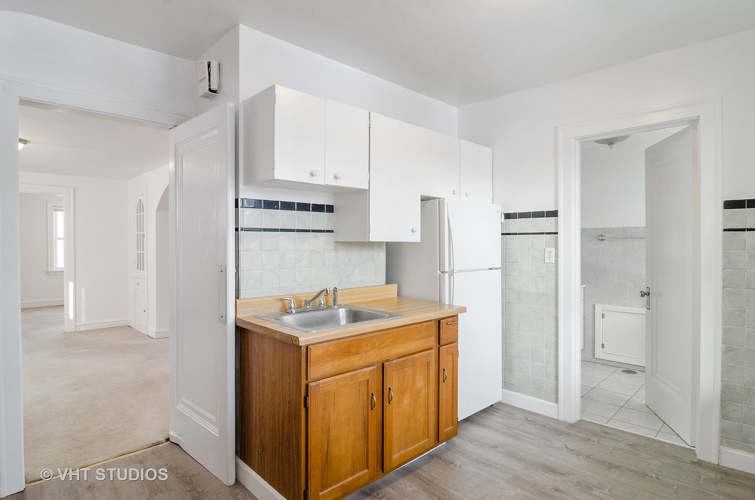 5219 North Rutherford Avenue, Unit 2 Chicago, IL 60656 - Photo 7 of 10 a kitchen with a sink a stove a refrigerator and cabinets