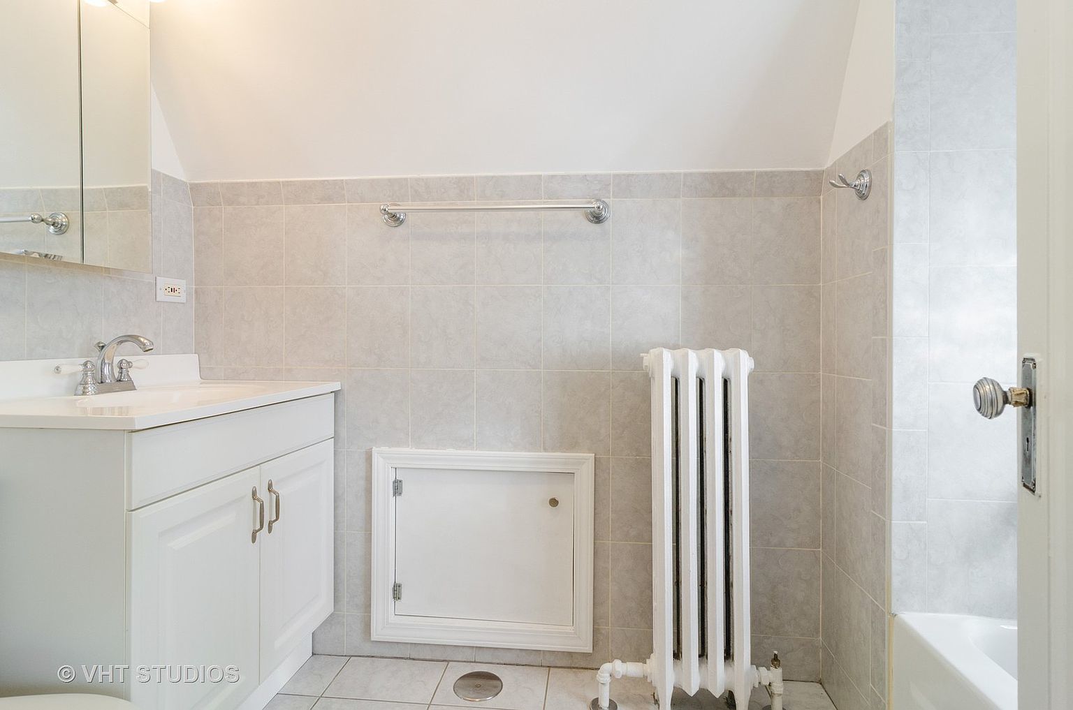 5219 North Rutherford Avenue, Unit 2 Chicago, IL 60656 - Photo 8 of 10 a bathroom with a sink a mirror and shower