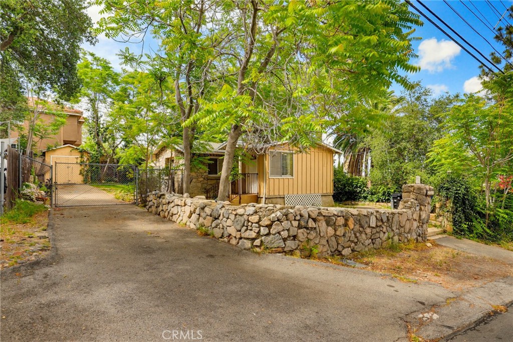 7264 Hillrose Street Tujunga, CA 91042 - Photo 1 of 27 a front view of a house with a garden