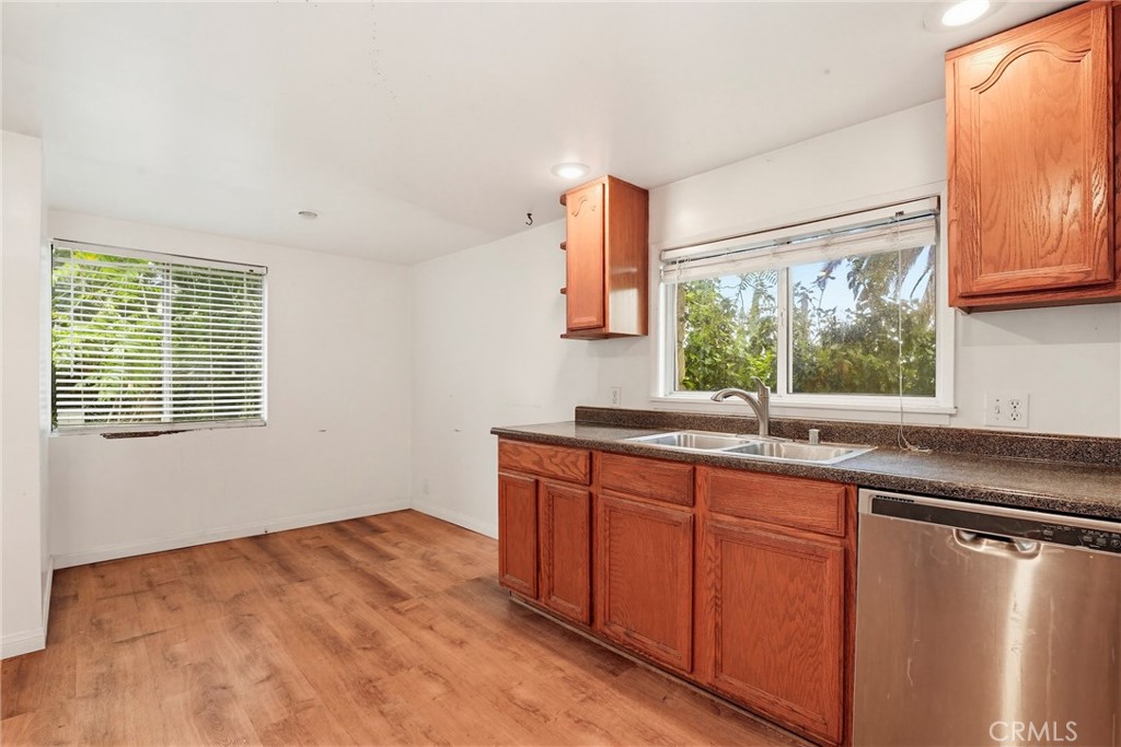 7264 Hillrose Street Tujunga, CA 91042 - Photo 12 of 27 a kitchen with stainless steel appliances granite countertop a sink window and cabinets