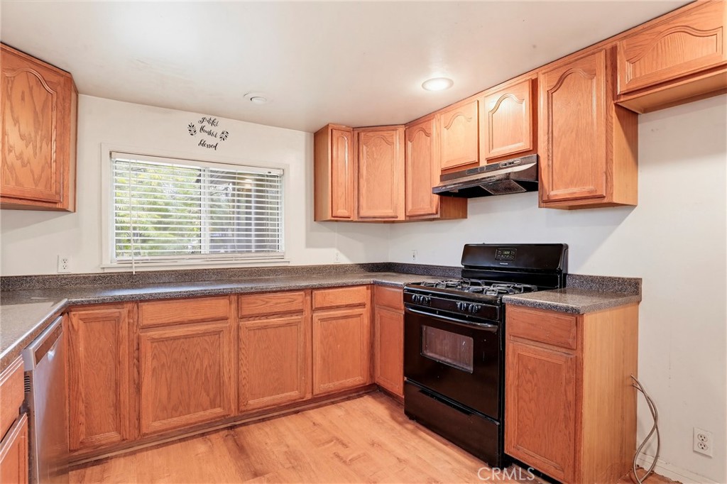 7264 Hillrose Street Tujunga, CA 91042 - Photo 13 of 27 a kitchen with stainless steel appliances granite countertop a stove a sink and a microwave