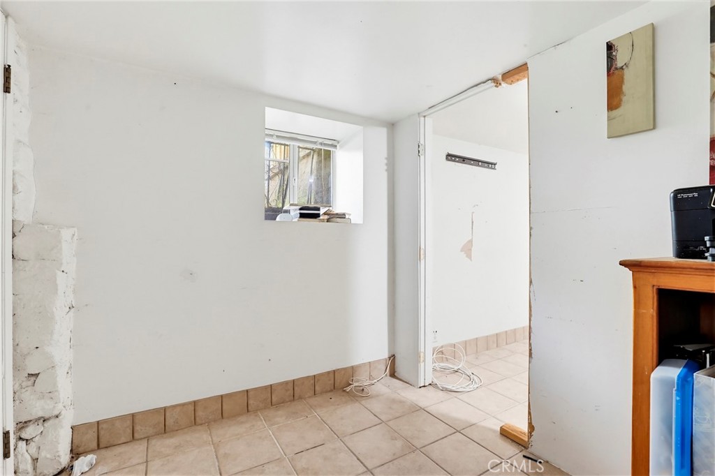 7264 Hillrose Street Tujunga, CA 91042 - Photo 21 of 27 a view of a hallway with wooden floor and staircase