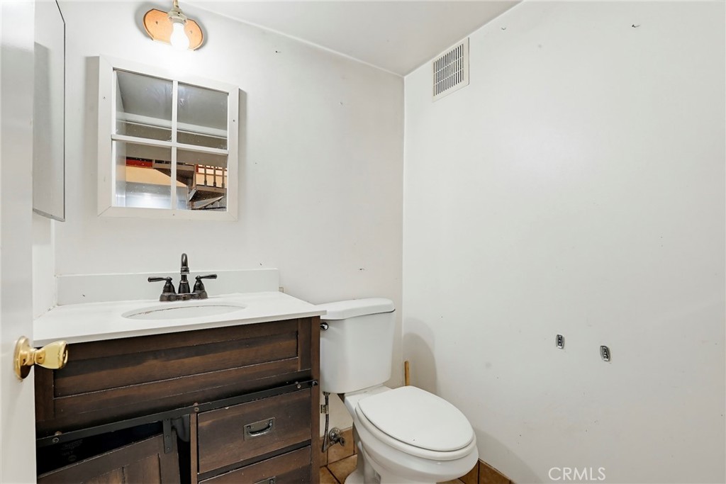 7264 Hillrose Street Tujunga, CA 91042 - Photo 22 of 27 a bathroom with a sink vanity mirror and toilet