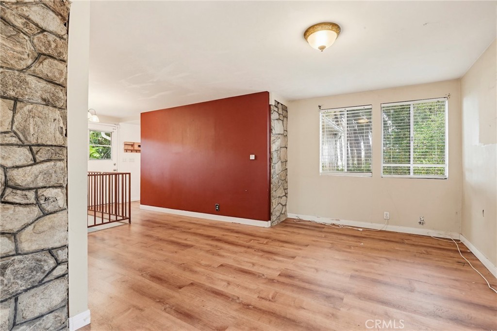 7264 Hillrose Street Tujunga, CA 91042 - Photo 5 of 27 an empty room with wooden floor and windows