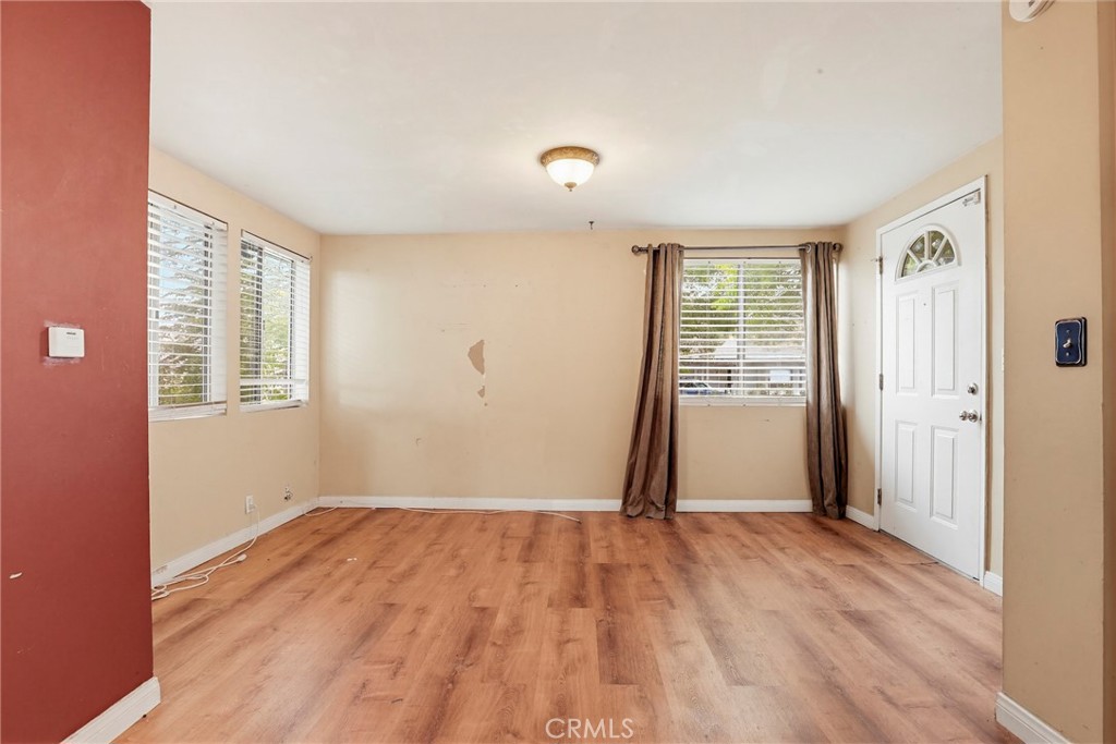 7264 Hillrose Street Tujunga, CA 91042 - Photo 7 of 27 an empty room with wooden floor and windows