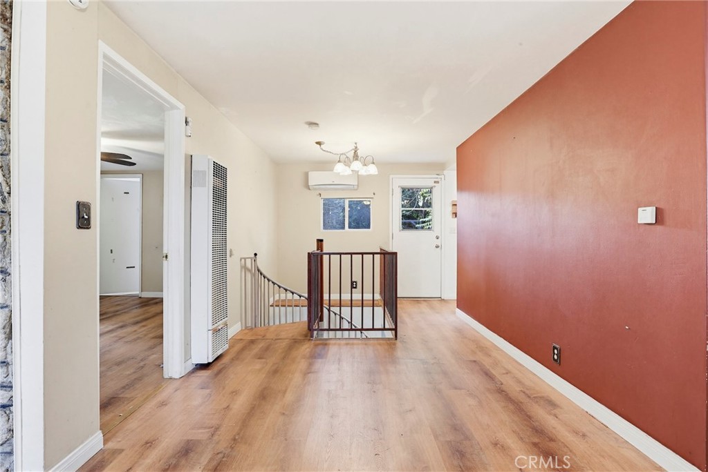 7264 Hillrose Street Tujunga, CA 91042 - Photo 8 of 27 a furnished livingroom with a window and wooden floor