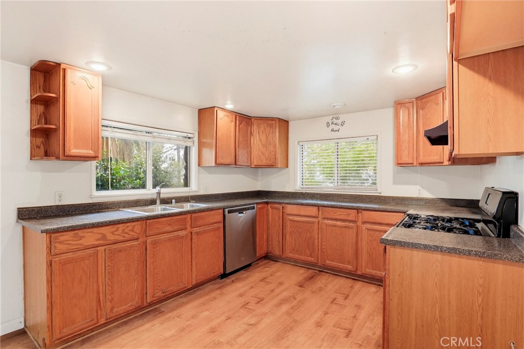 7264 Hillrose Street Tujunga, CA 91042 - Photo 10 of 27 a kitchen with stainless steel appliances granite countertop a sink stove and cabinets