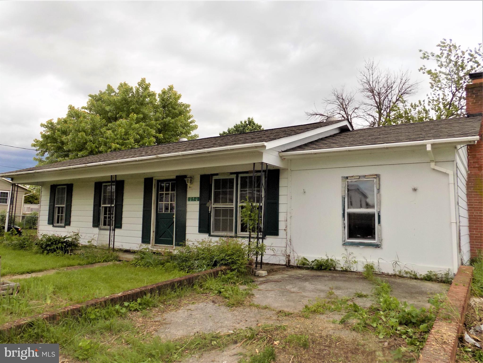 Front View with Covered Porch and Parking Area