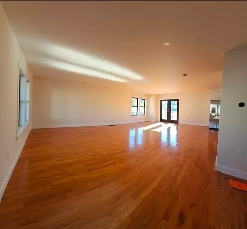 a view of room with window and wooden floor