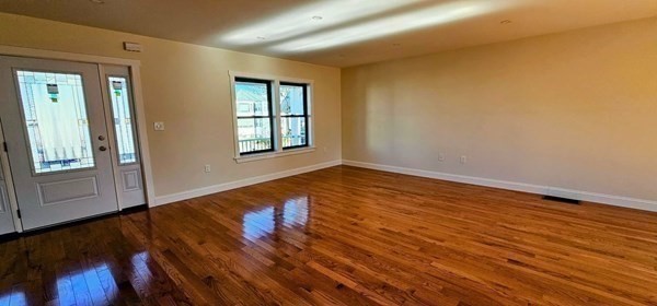 31 Niagara Street Fall River, MA 02721 - Photo 7 of 12 a view of an empty room with wooden floor and a window