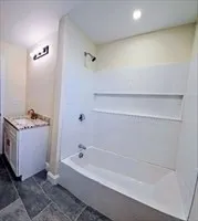a bathroom with a bathtub and shower