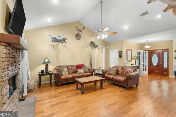a living room with furniture fireplace and flat screen tv