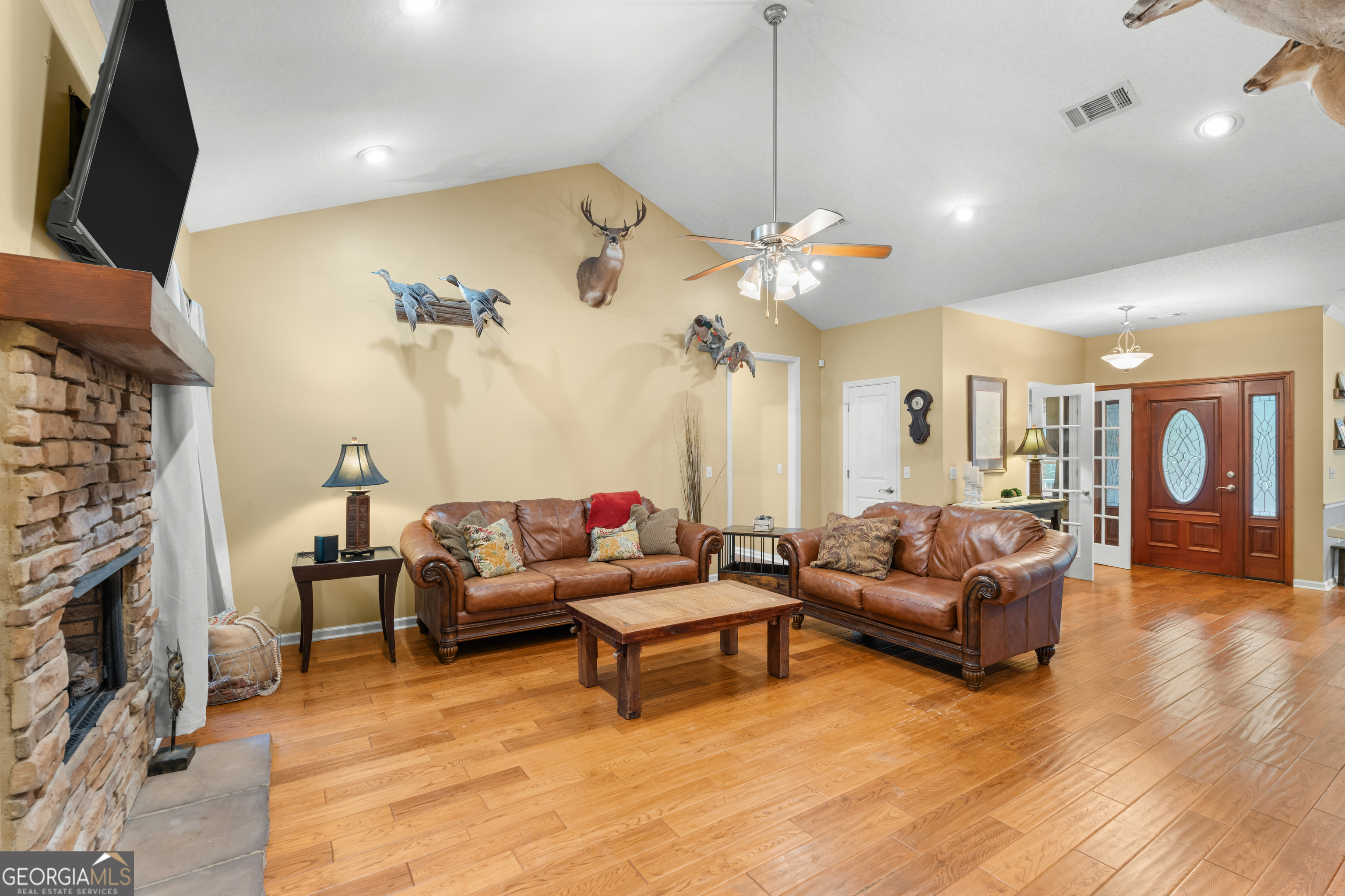 480 Best Bridge Road Sylvania, GA 30467 - Photo 11 of 57 a living room with furniture a fireplace and a chandelier