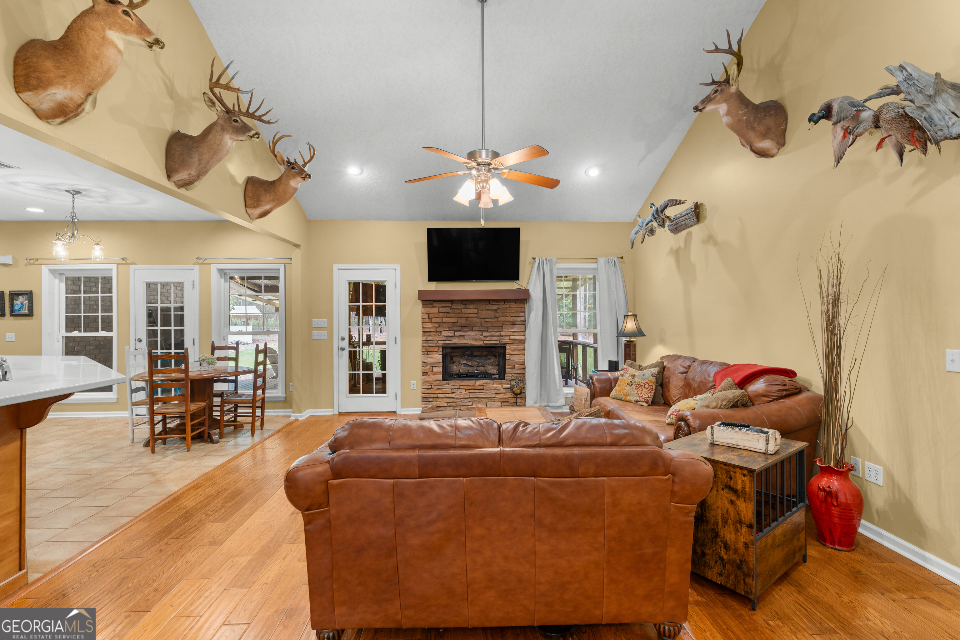 480 Best Bridge Road Sylvania, GA 30467 - Photo 12 of 57 a living room with furniture a fireplace and a chandelier
