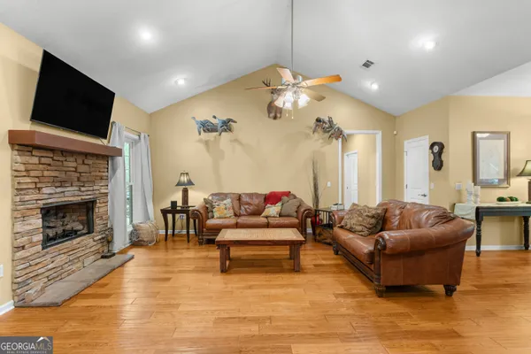 a living room with furniture and kitchen view