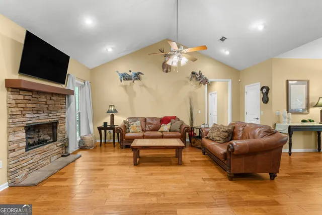 a living room with furniture and kitchen view