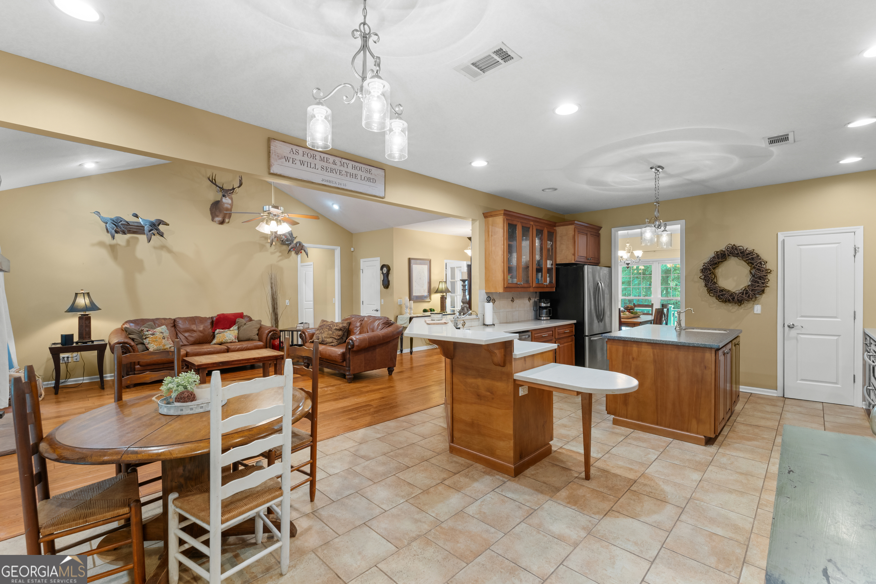 480 Best Bridge Road Sylvania, GA 30467 - Photo 16 of 57 a view of a dining room and livingroom with furniture a rug a fireplace and a chandelier