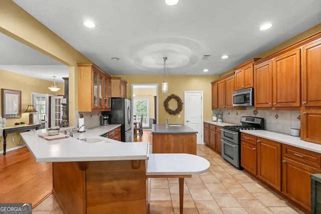 a kitchen with stainless steel appliances granite countertop a sink stove and refrigerator
