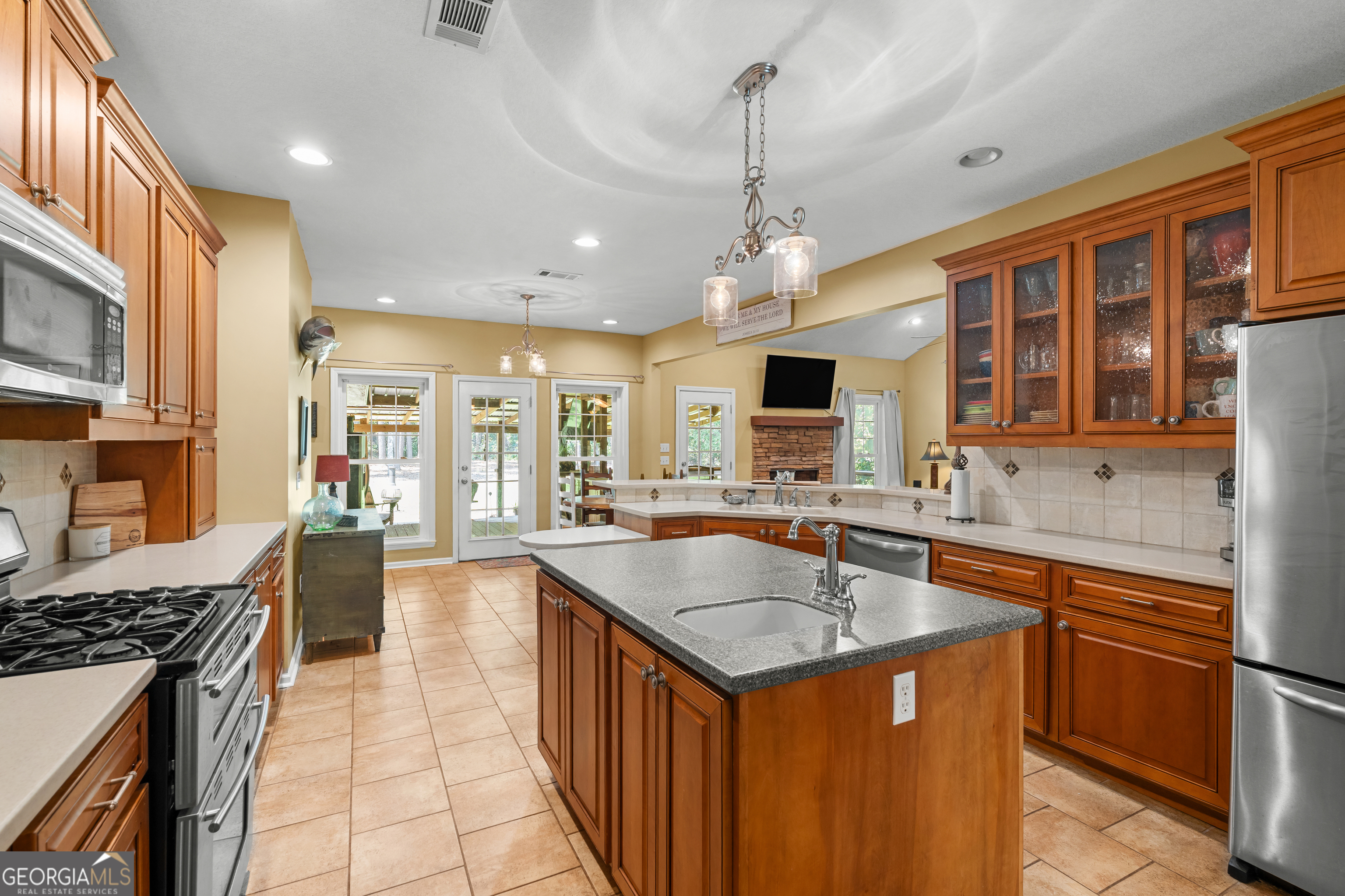 480 Best Bridge Road Sylvania, GA 30467 - Photo 19 of 57 a kitchen with stainless steel appliances granite countertop a sink stove and refrigerator